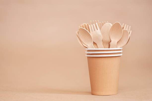 istock Environmentally friendly disposable tableware. Wooden spoons and forks in paper cups 1345267409