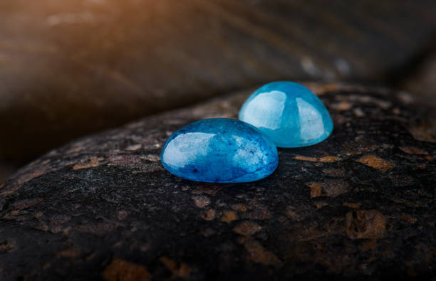 Natural blue zircon on the dark stone.
