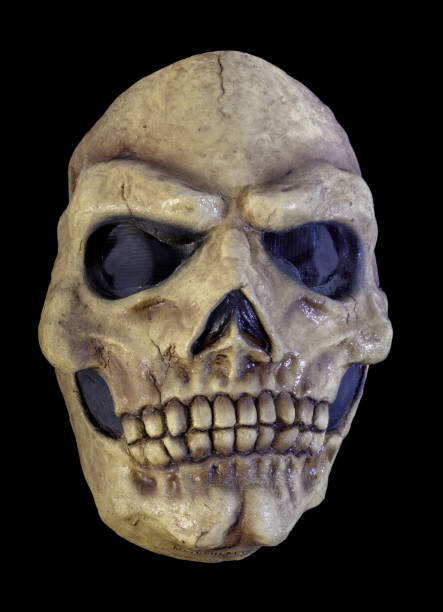 istock Yellowed Skull Mask Isolated Against Black Background 1345269477