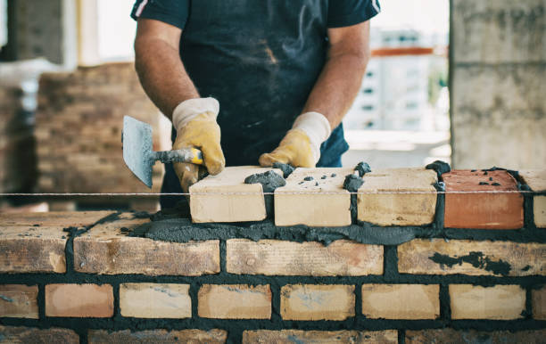 Building a brick wall Closeup front view of an unrecognizable construction worker building a brick wall reinforced concrete stock pictures, royalty-free photos & images