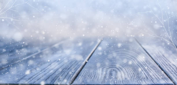 istock Snow-covered wooden panel with a winter forest background 1345270806