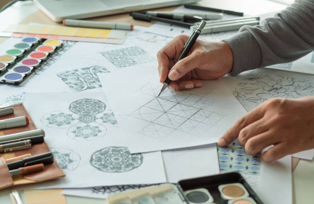 istock Designer designing drawing sketch pattern geometric flower seamless wallpaper fabric textile fashion industry. artistic design studio. 1345271812