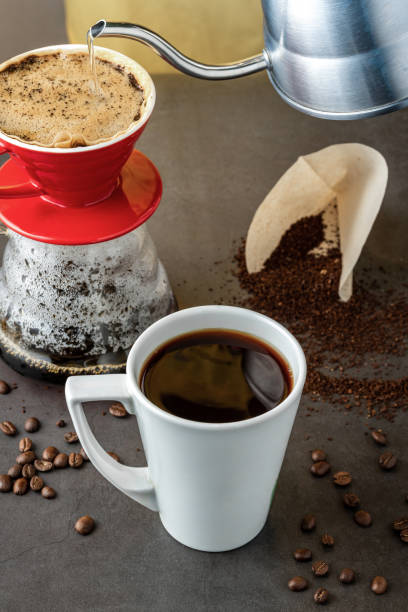 istock A cup of coffee and third generation pour over coffee brewing equipment on stone floor 1345276301