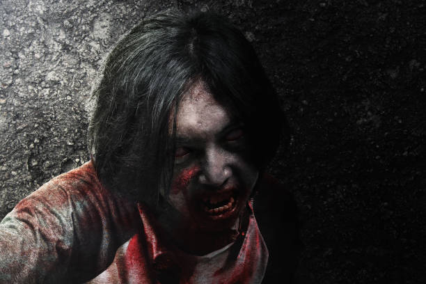 istock Scary zombie with blood and wound on his body crawling 1345278322