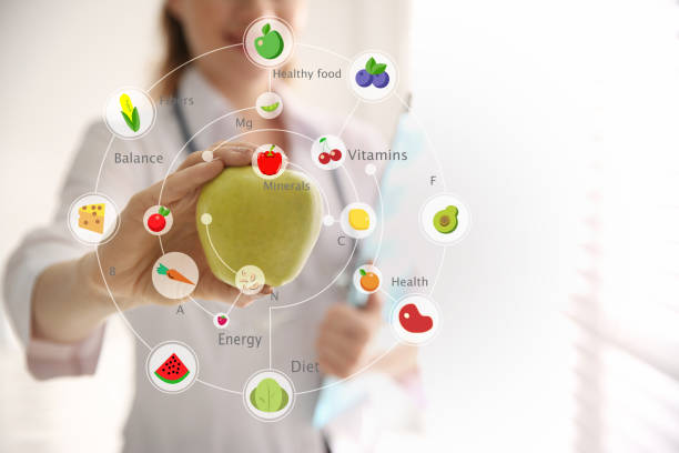 istock Nutritionist's recommendations. Doctor with apple in office, closeup 1345279712
