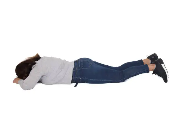 rear view of a woman lying on the floor face down on white background