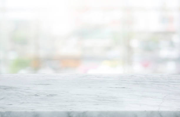 istock Selective focus.Marble table top on blur abstract window glass background 1345281194