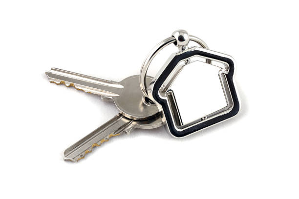 istock Two silver keys with metal house figure 134528135