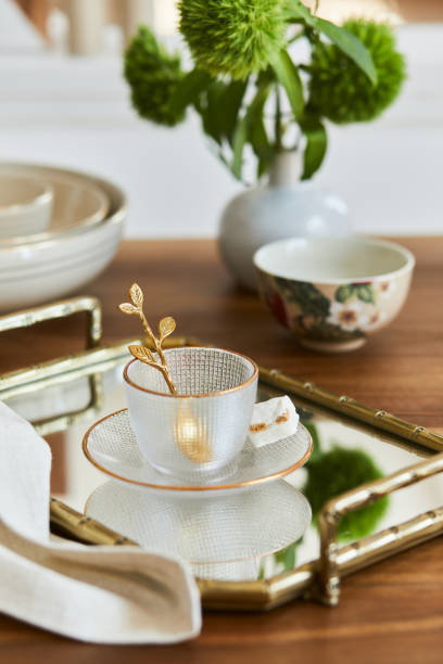 istock Creative and elegant dining room composition with classy porcelain, golden tray and beautiful personal accessories. Luxury apartments. Beauty in the details. Template. 1345281512