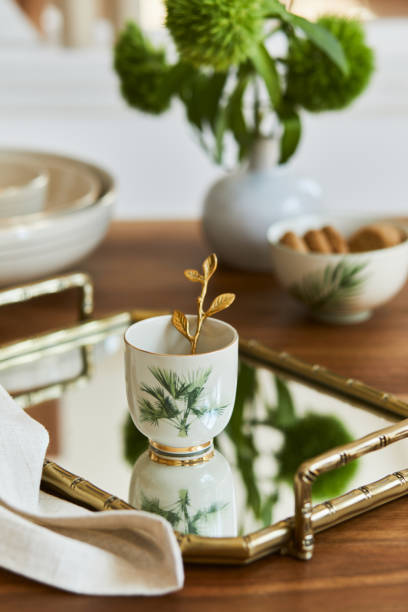 istock Creative and elegant dining room composition with classy porcelain, golden tray and beautiful personal accessories. Luxury apartments. Beauty in the details. Template. 1345281565