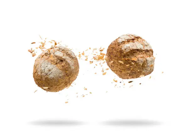 Bread jumping with crumbs on white background