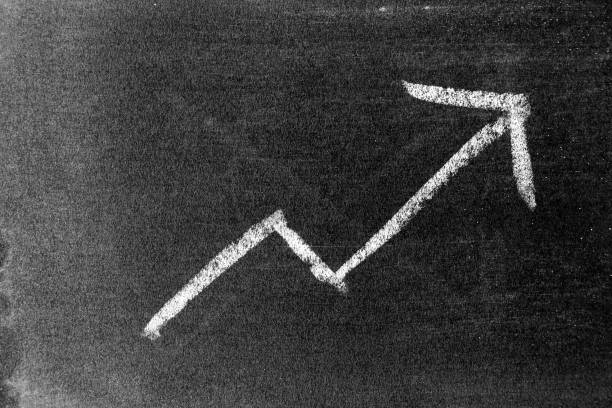 istock White chalk draw as upward arrow graph on blackboard or chalkboard background (Concept for sale, profit, cost of company in uptrend) 1345287694