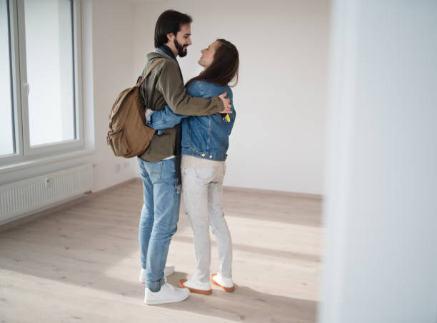 istock Young couple hugging and moving in new flat, new home and relocation concept. 1345287727