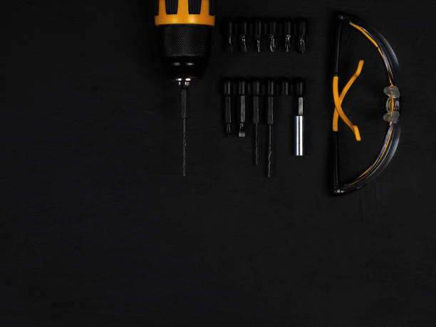 istock Cordless cordless drill - screwdriver with drill. Construction tools set. Black background. Goods for repair. Professional repair equipment. 1345288507