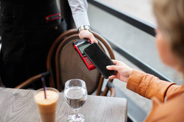 istock Paying by smart phone in the coffee shop 1345288652