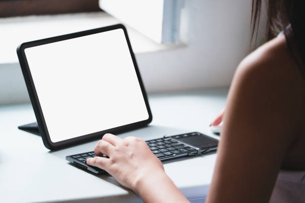 istock Business Women use a tablet for work, a blank tablet screen can add text or other media 1345288951