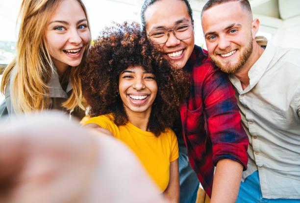 istock Multicultural happy friends having fun taking group selfie portrait - Young people smiling together at camera - International students at university college campus - Youth and friendship concept 1345290441