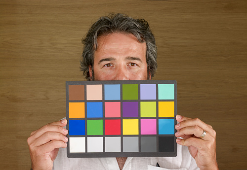 Man holding color rendition chart