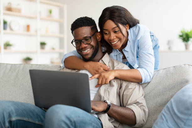istock Portrait of African American couple using computer pointing at screen 1345291433