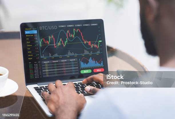 Cropped Of Black Businessman Analysing Market Online On Laptop Stock Photo - Download Image Now