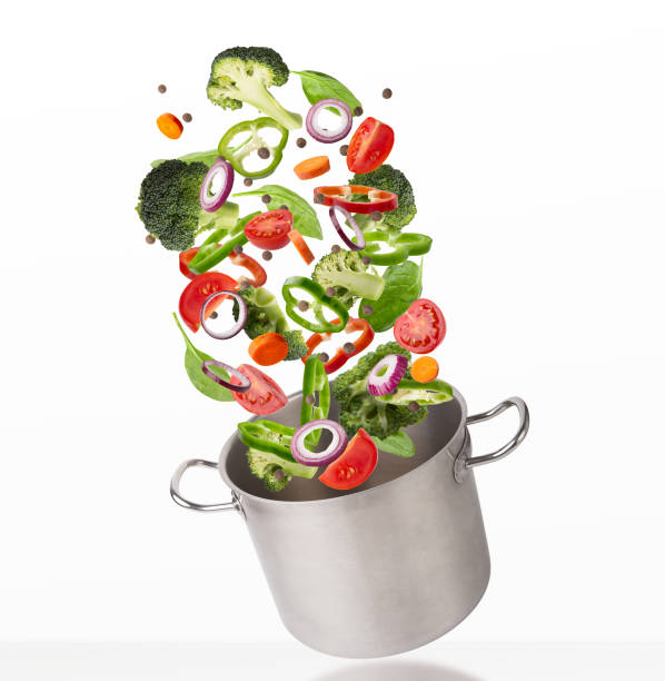 istock Fresh vegetables flying into steel pot, isolated on white background 1345291972