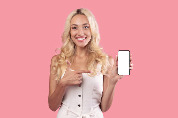 istock Woman holding and pointing at white empty smartphone screen 1345292906