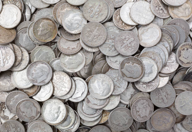 istock Wide view of old silver dimes illuminated with natural light. 1345294175