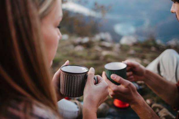 istock Couple of campers holding tea cups 1345294193