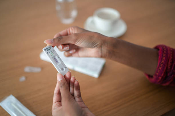 istock Woman's Hands Holding A Rapid Antigen Self Test 1345296752