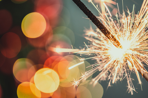 Close-up of holiday Christmas sparkler on dark background