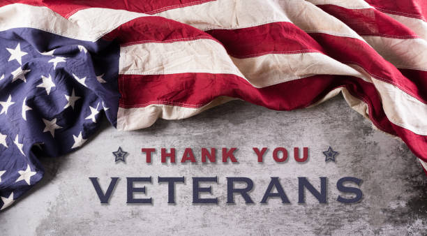 Happy Veterans Day concept. American flags against a dark stone  background. November 11. Happy Veterans Day concept. American flags against a dark stone  background. November 11. thank you veterans day stock pictures, royalty-free photos & images