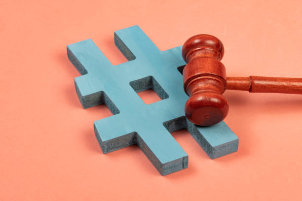 istock hashtag and justice hammer symbolizing cyber crimes 1345298258