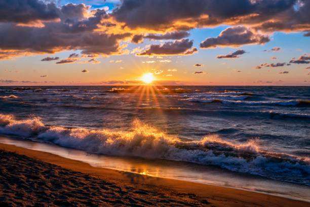 Stunning Lake Erie Beach Sunset Lake Erie beach sunset with waves crashing lake erie stock pictures, royalty-free photos & images