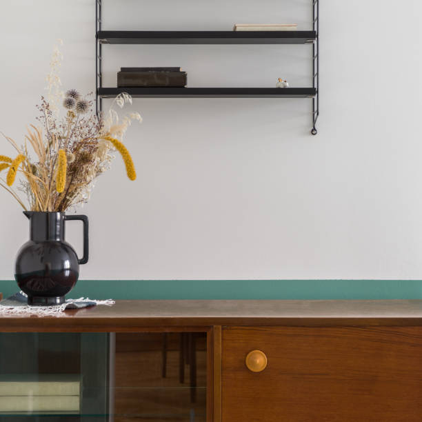 istock Decorative vase on retro style sideboard, close-up 1345299442