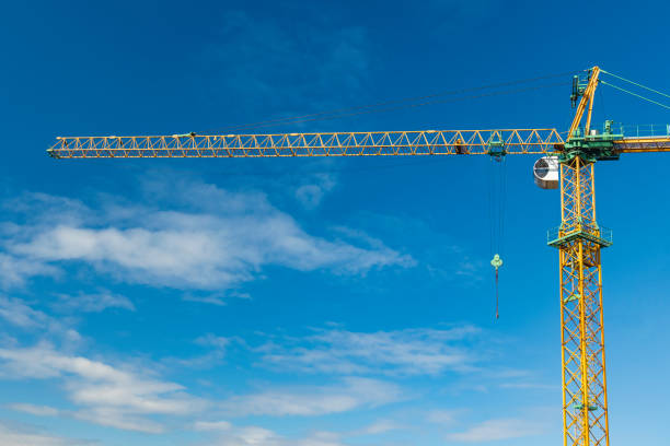 construction object high building crane on blue sky background simple industrial concept photography for advertising goal with space for text