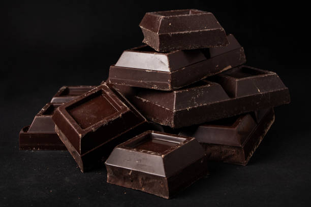 istock Pieces of dark chocolate on a dark background 1345301432