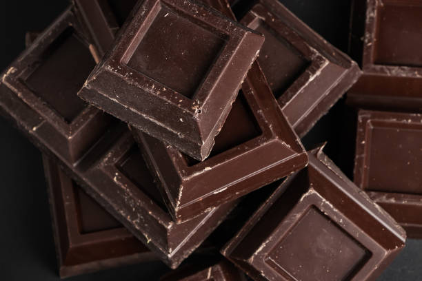 istock Broken pieces of dark chocolate close up 1345301441