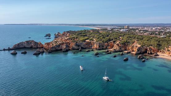 Beautiful seascape from the air, paradise bay with a yacht, Portuguese beaches, algarve. High quality photo