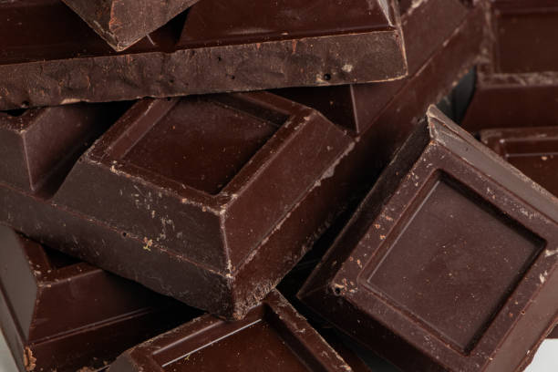 istock Broken pieces of dark chocolate close up 1345301722