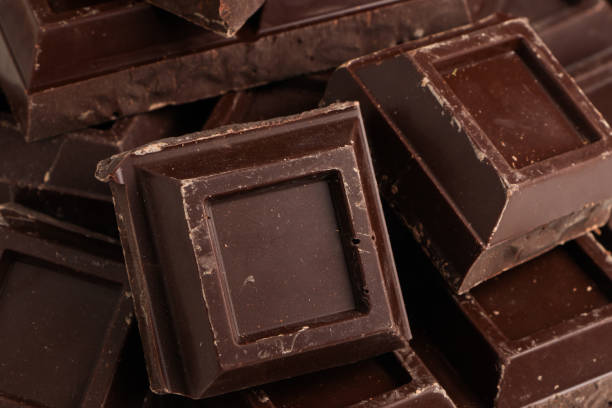 istock Broken pieces of dark chocolate close up 1345301855