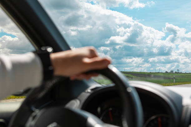 istock man hands on steering wheel cloudy sunny day 1345303577