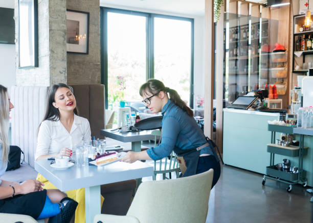 istock Young woman with Down Syndrome working at cafe 1345306168