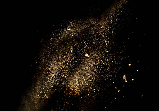 istock Dust and wood chips on a black background. Dirt particles fly in the air. Layout for design. Some dust particles are blurred to transmit the effect of motion. 1345307228