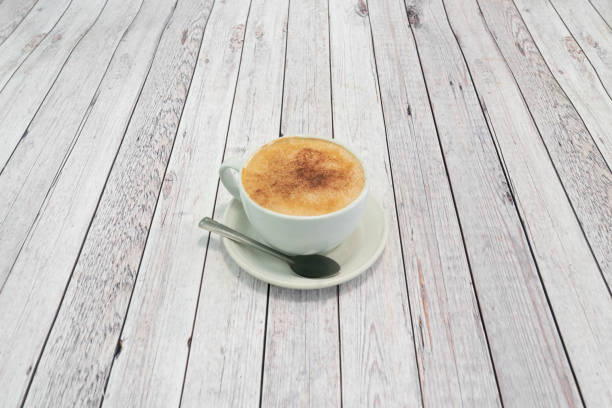 Cappuccino on grey wooden table stock photo
