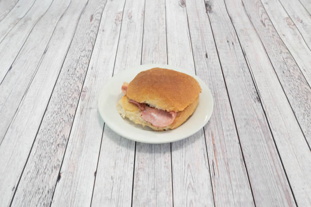 Breakfast Bacon Roll on grey wooden table stock photo