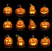 Halloween pumpkins faces glowing in darkness