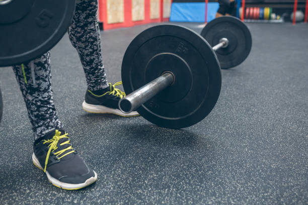istock Dumbbell next to unrecognizable sportsman legs 1345308002