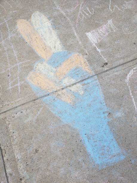 istock Chalk drawing showing the peace or victory sign 1345308032