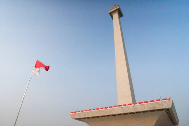 istock Indonesian flag on National Monument Monas on clear afternoon sky 1345309302