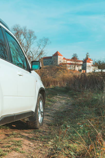 istock suv car on the road to old castle. 1345309493
